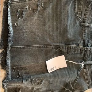 Distressed black denim skirt